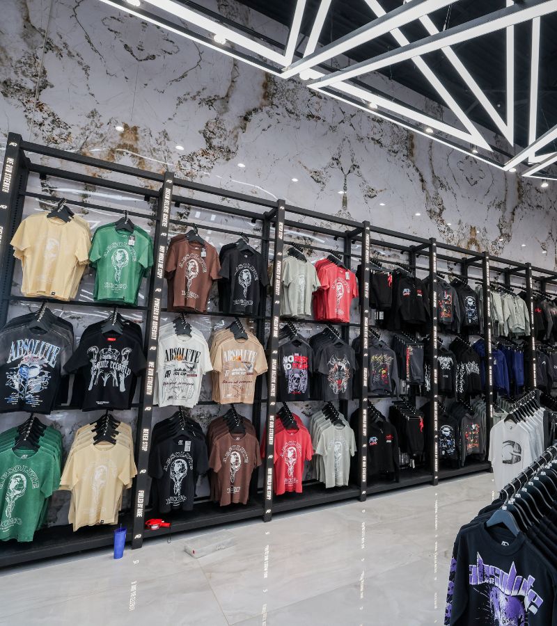 Branded apparel wall and retail display inside Absolute Recomp Arlington.