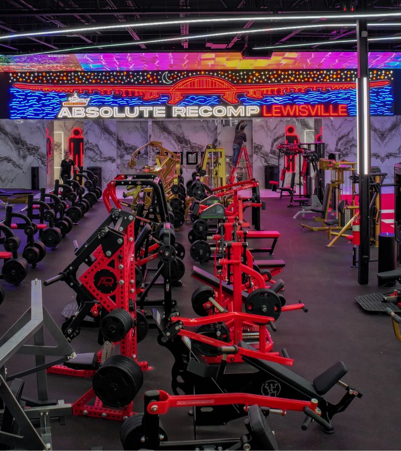 Strength training equipment at Absolute Recomp Lewisville with world-class machines, free weights, and a hardcore bodybuilding environment.