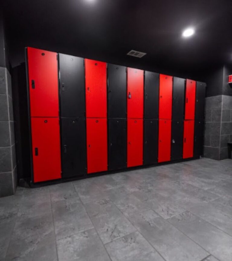 Modern red and black gym lockers at Absolute Recomp North Richland Hills, providing secure storage in a premium fitness environment.